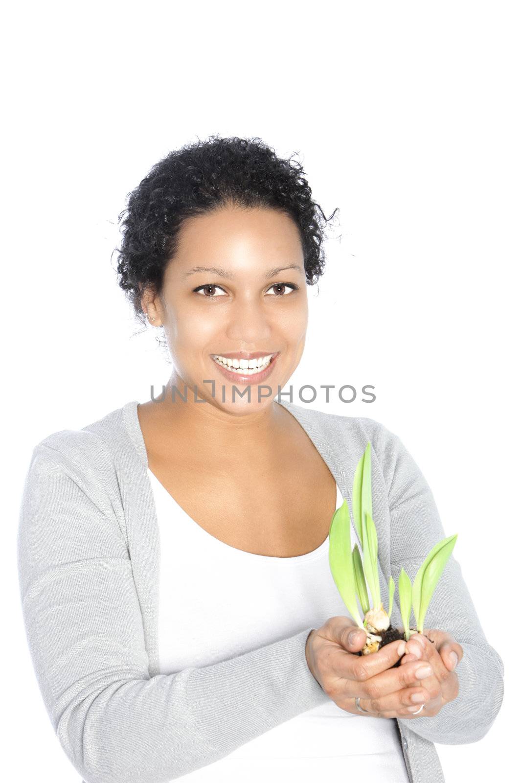 Smiling beautiful African American woman holding sprouting sping bulbs in her cupped hands isolated on white