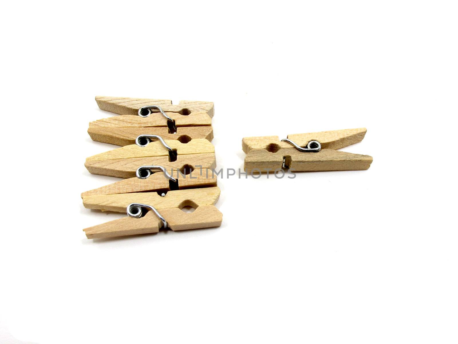 Five wooden pins with one is separated on white background