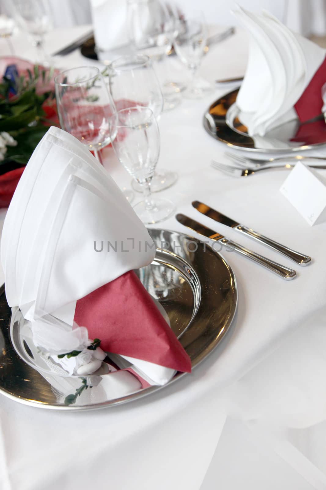 Elegant formal table setting at a function with silverware and decorative folded napkins