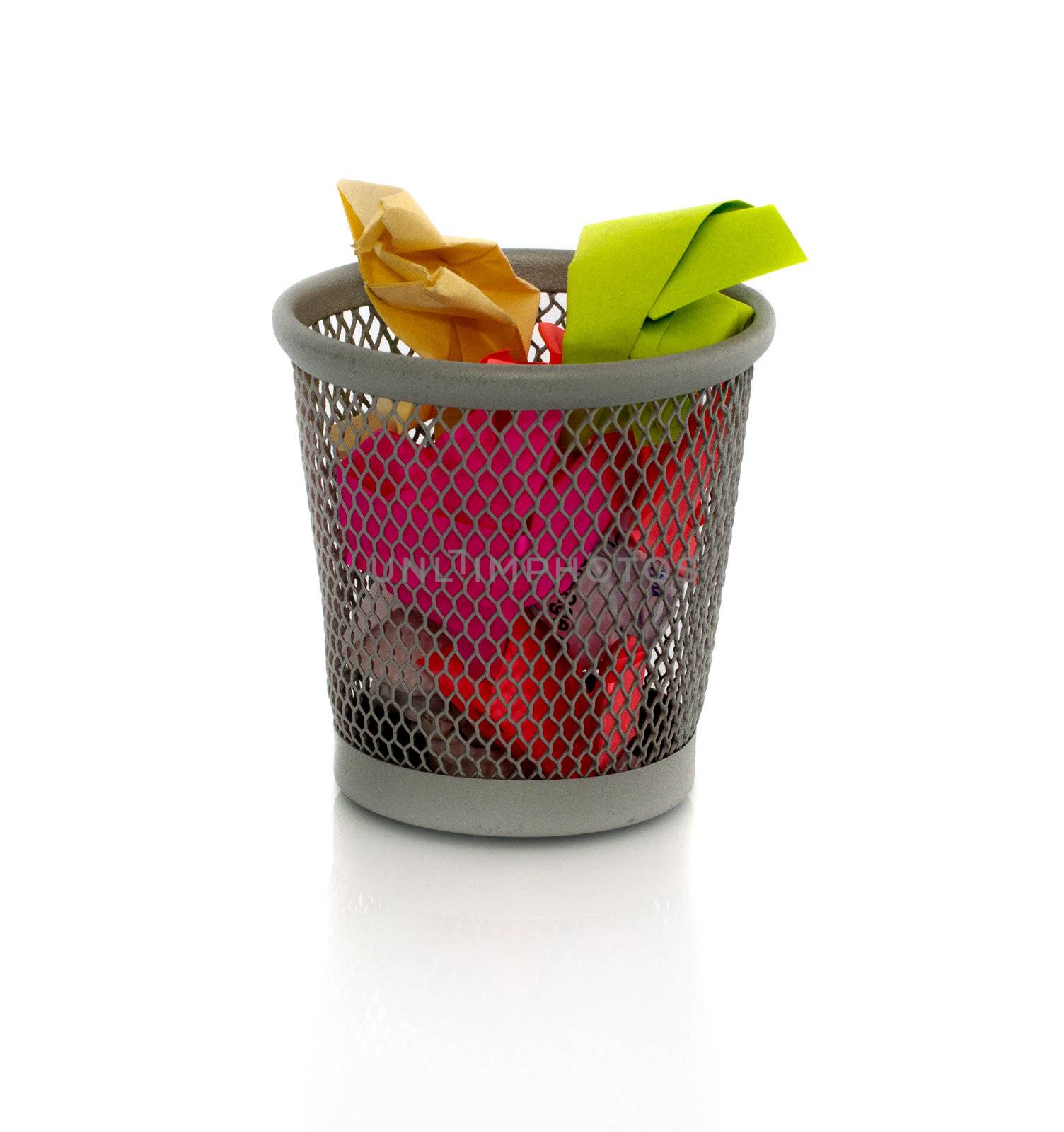 colored paper in waste basket as trash