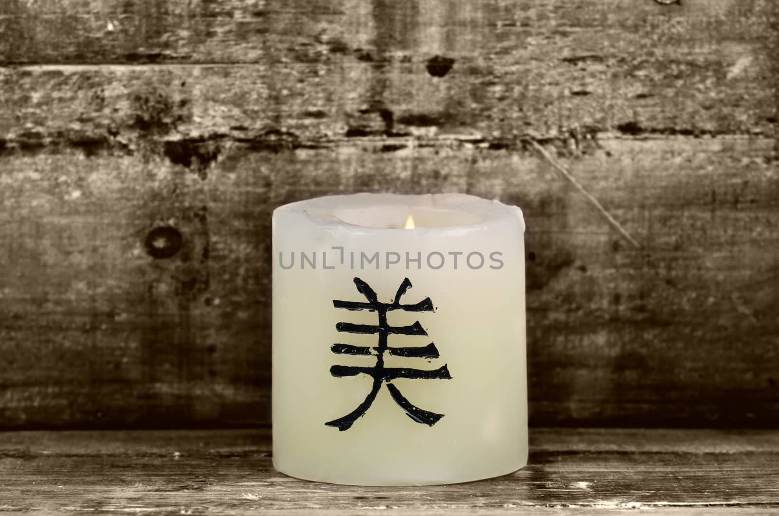 a candle on wooden background