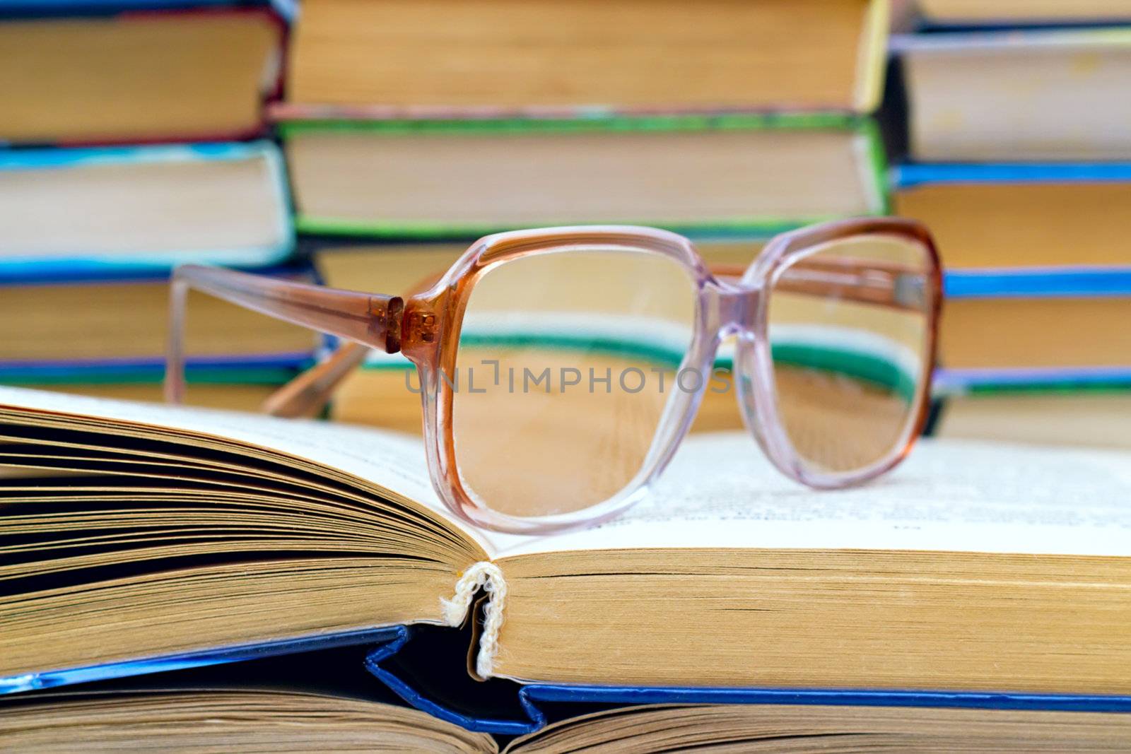 	
reading glasses lying on the open book
