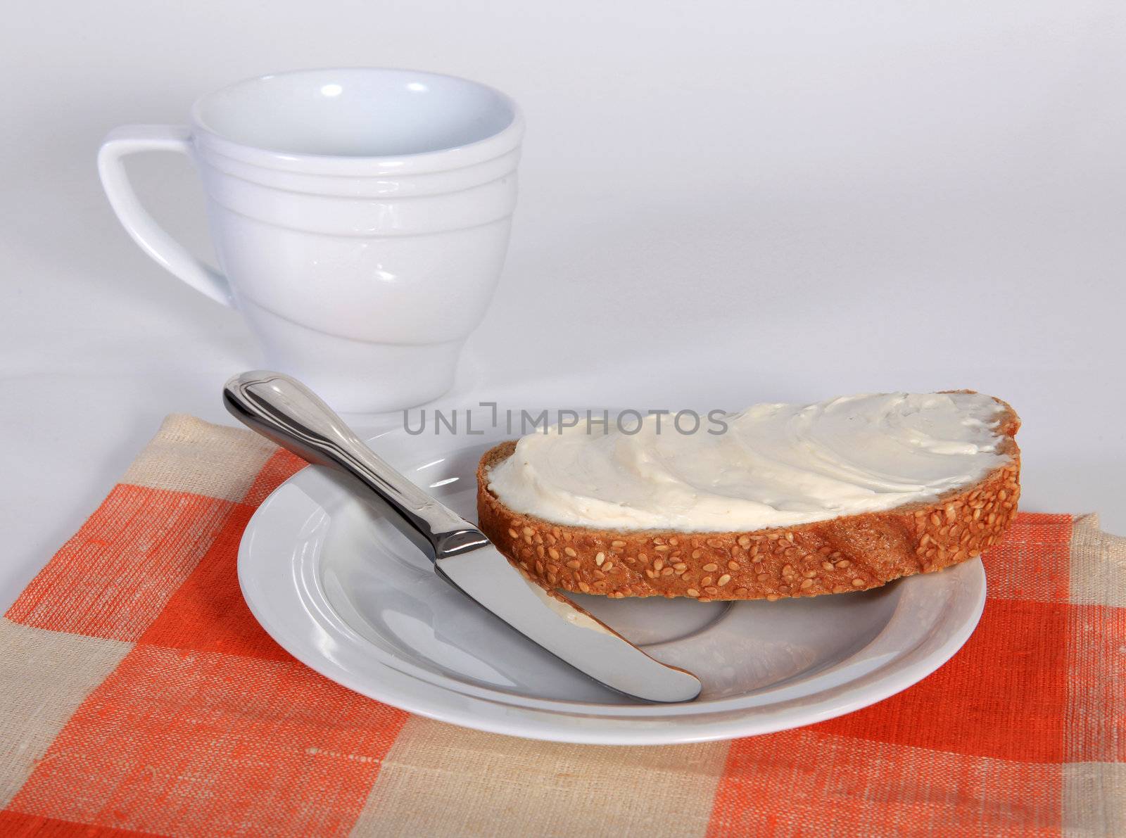 Appetizing sandwich with butter on the white saucer
