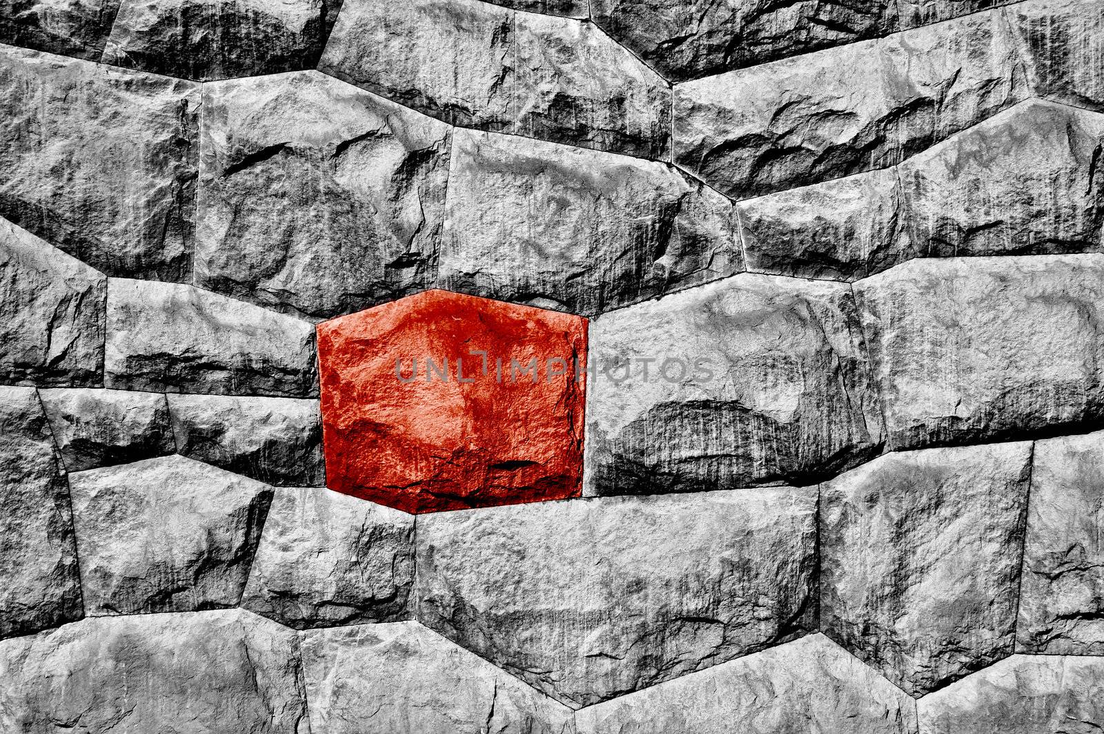 Stone wall with a odd red stone.