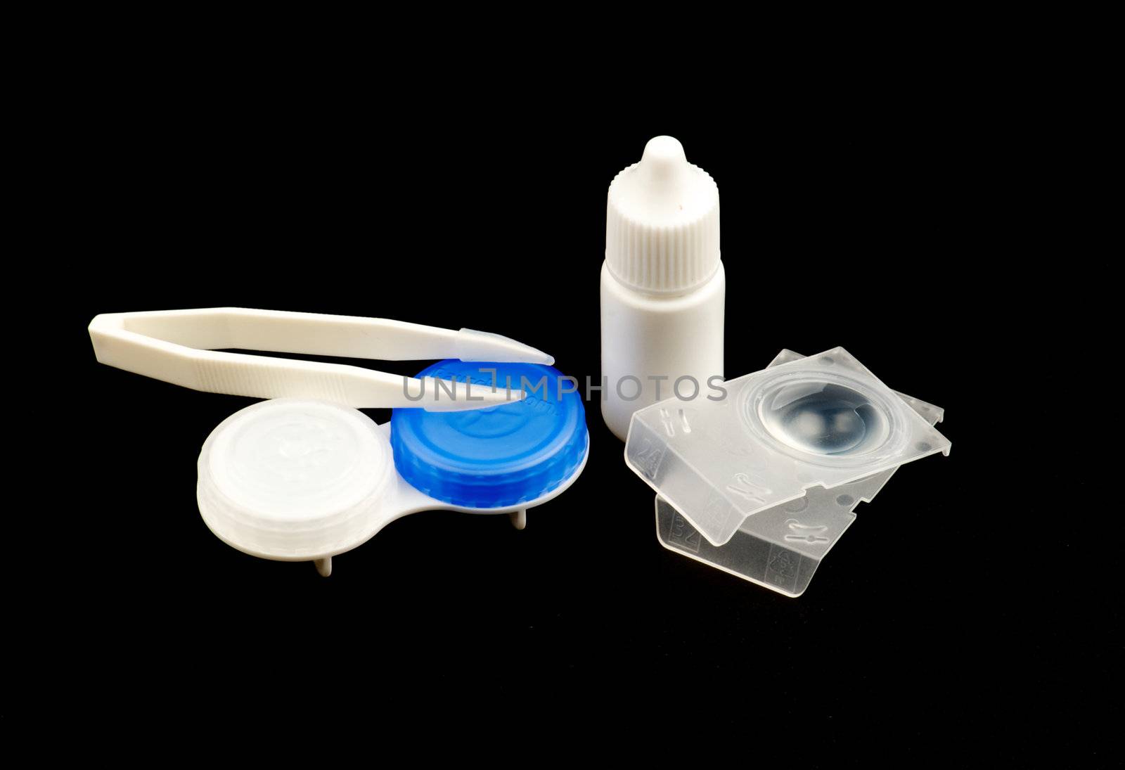 Contact lens case and accessories isolated on black background