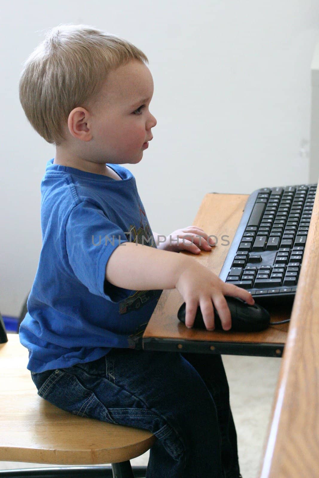 Young boy "working" at the computer