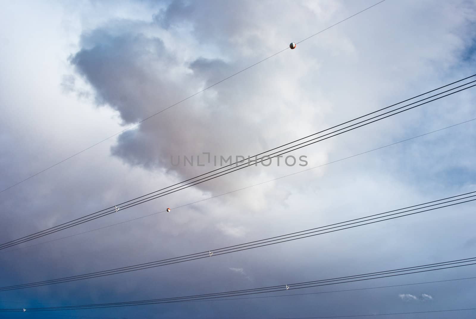 Power lines against a  stormy sky