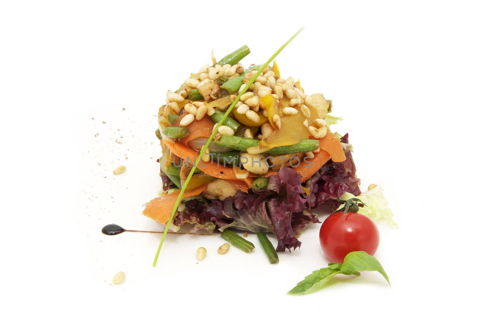 salad with vegetables and pine seeds on a white background