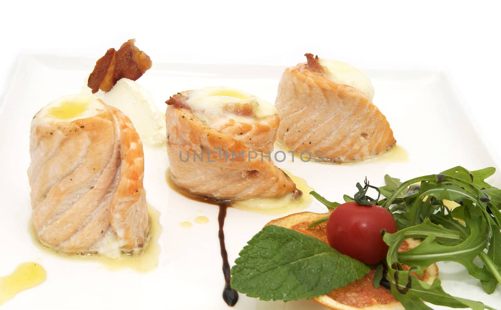 rolls of fried fish with vegetables on a plate