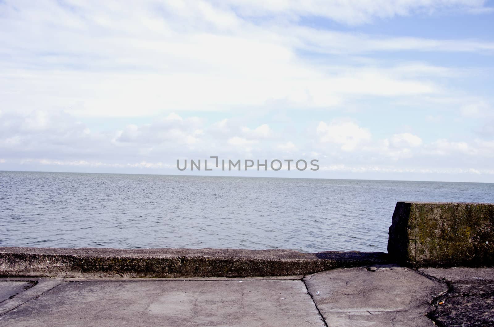 Old concrete pier for ships and sea sky background by sauletas