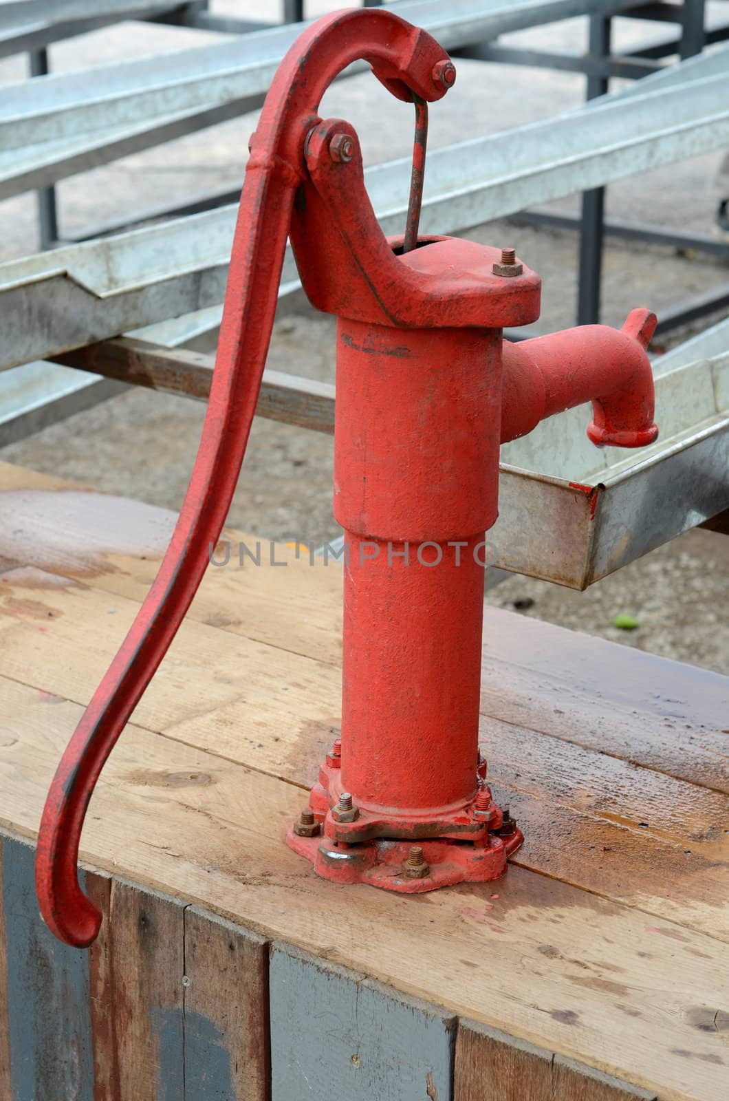 Traditional red Iron water pump by nuttakit