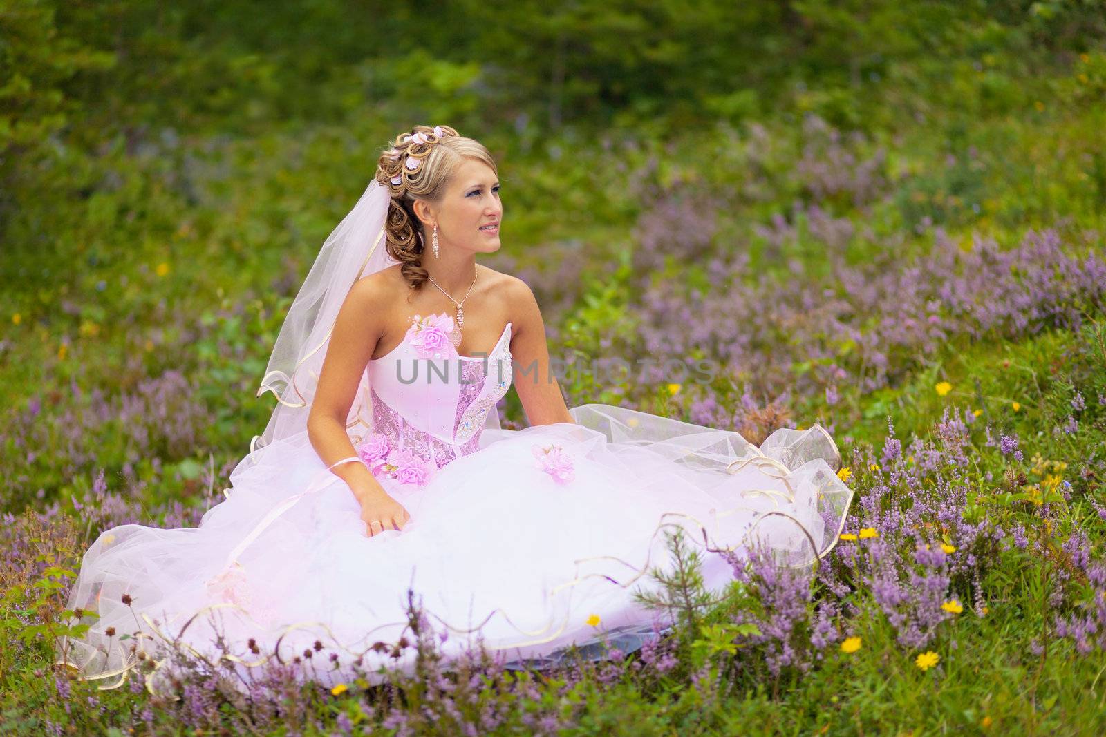 Beautiful bride is sitting in the forest by pzaxe