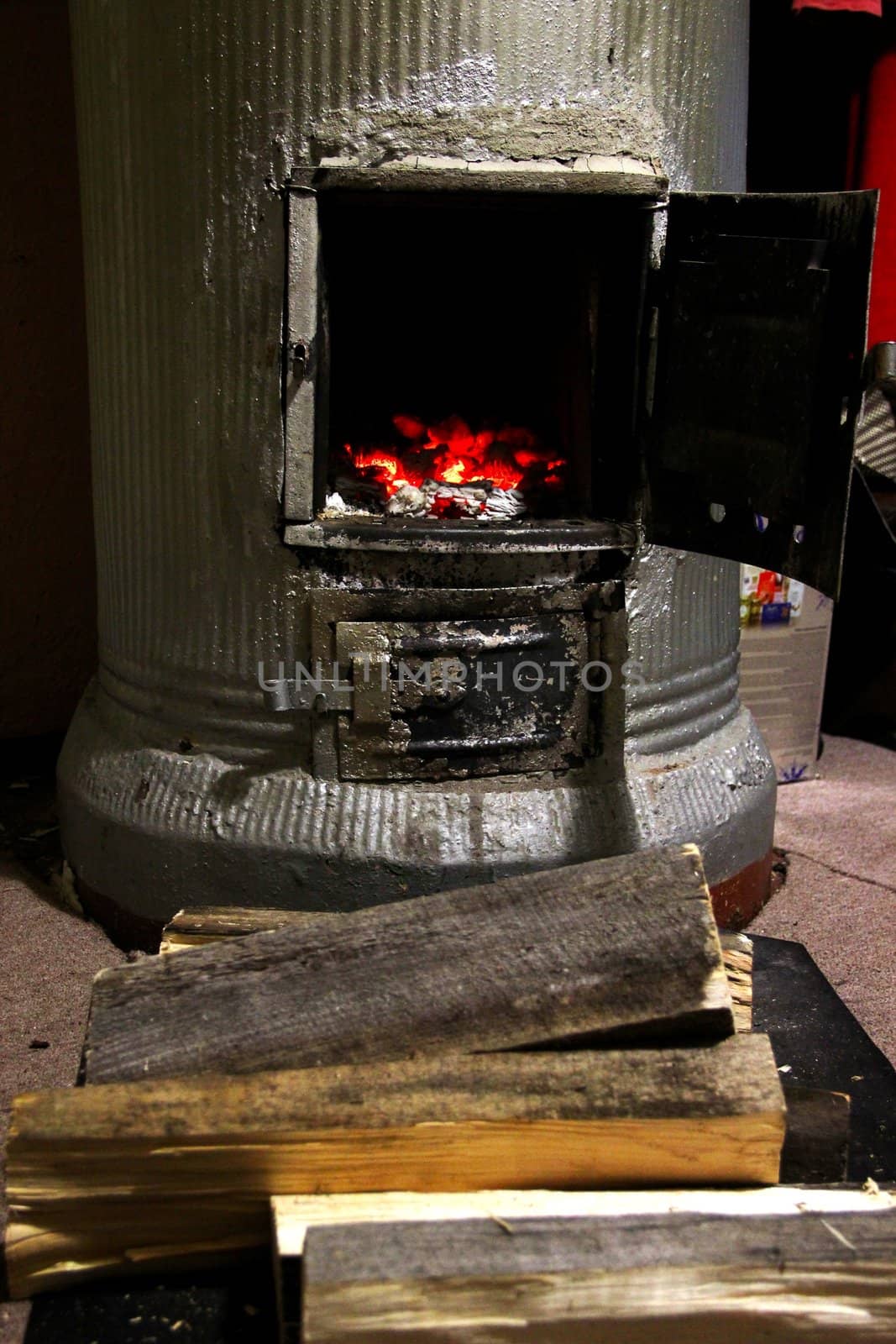 an old stove with burning coals and wood