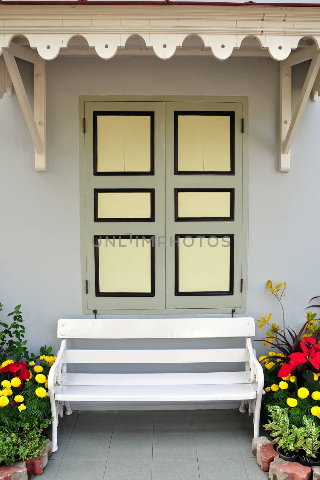 A picture of White chair against window and wall