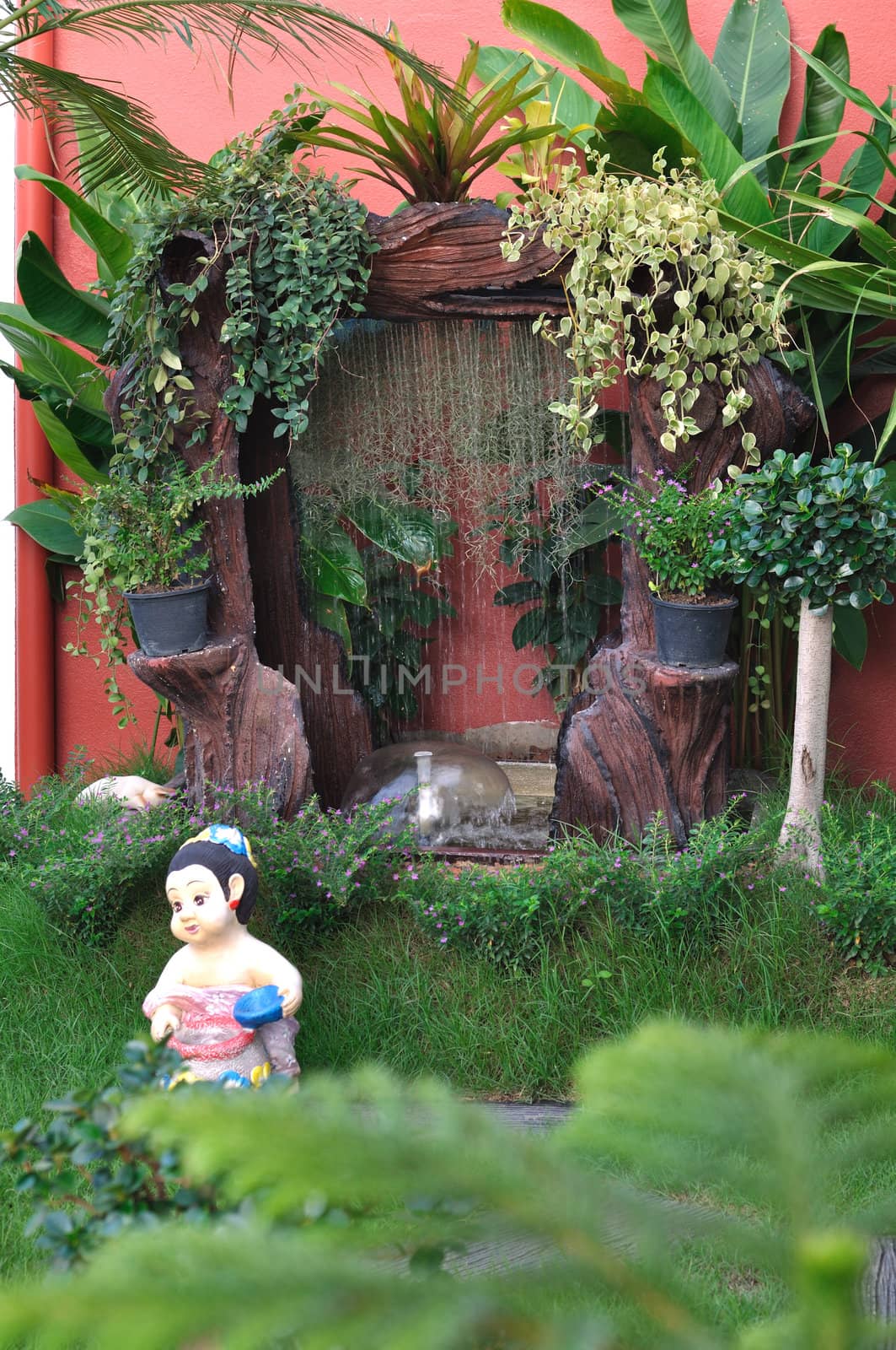 Clay Doll and Waterfall in the garden.