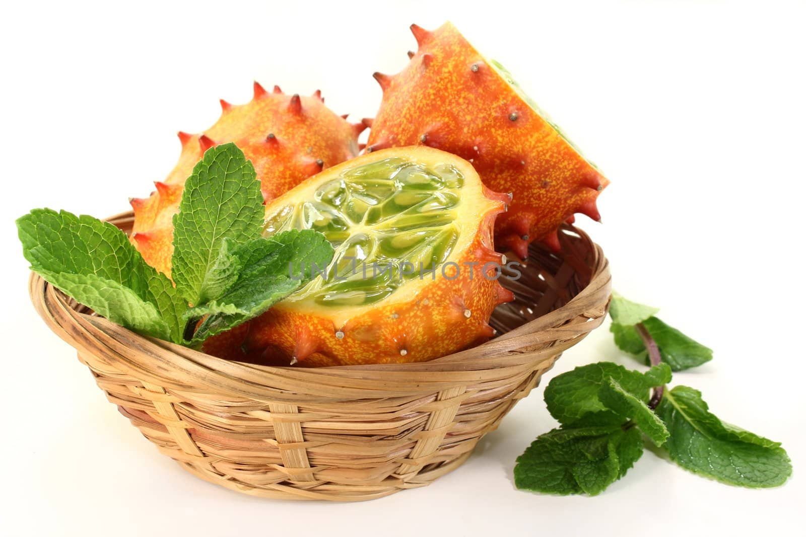 a basket Kiwano on a white background