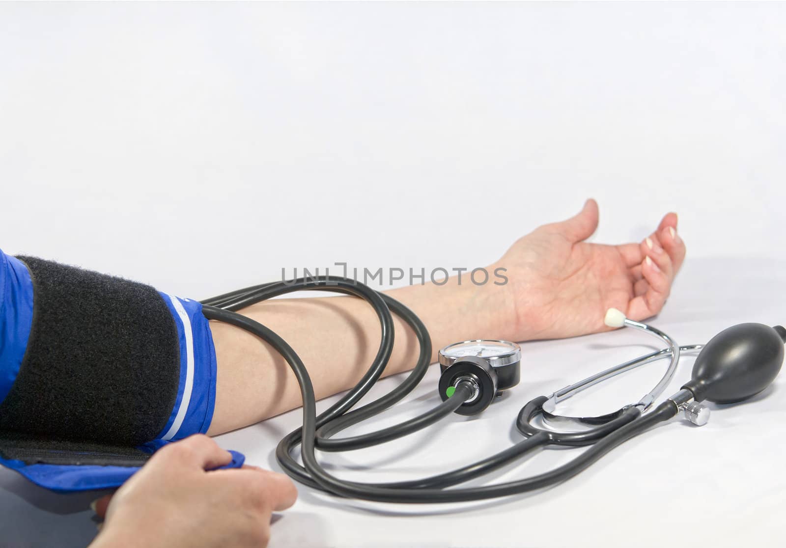 Woman's arm and blood pressure sphygmomanometer