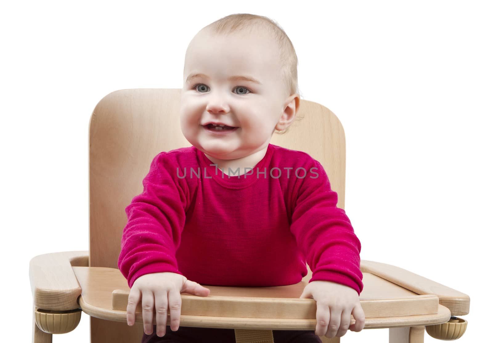 young child sitting in high chair by gewoldi