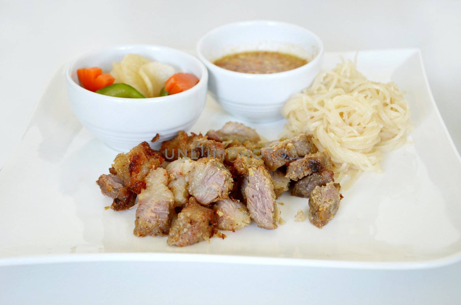 grilled pork served with sweet sauce and vegetable , noodle