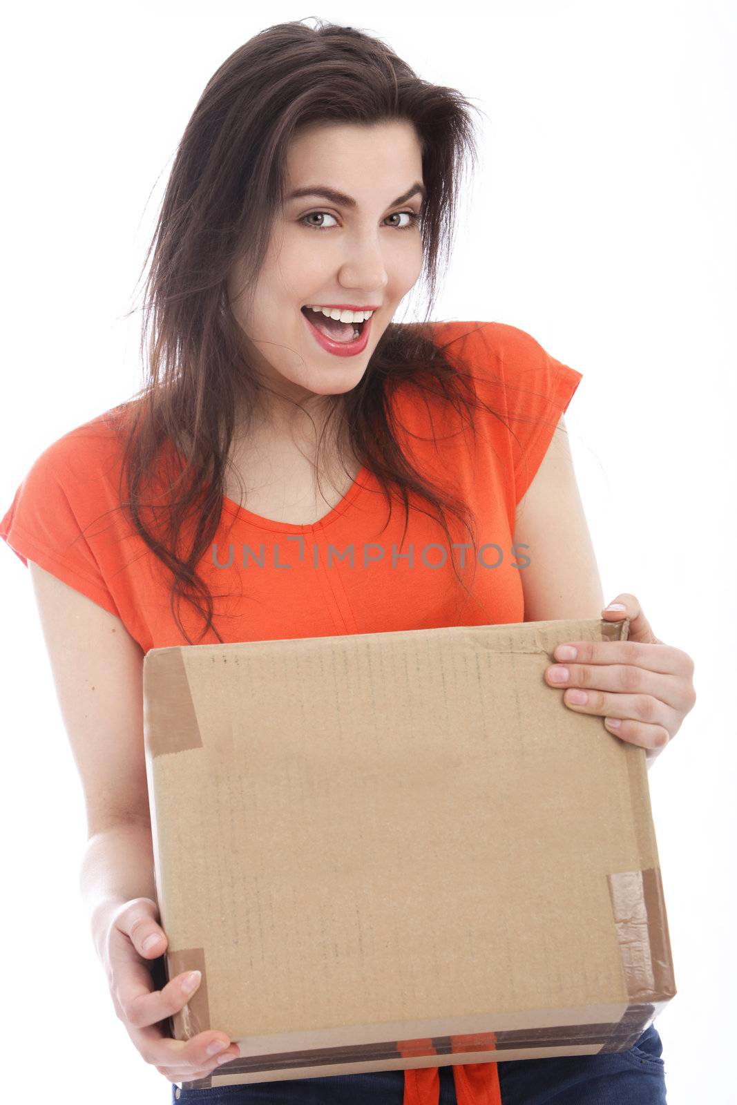 Happy young Caucasian woman holding a cardboard box