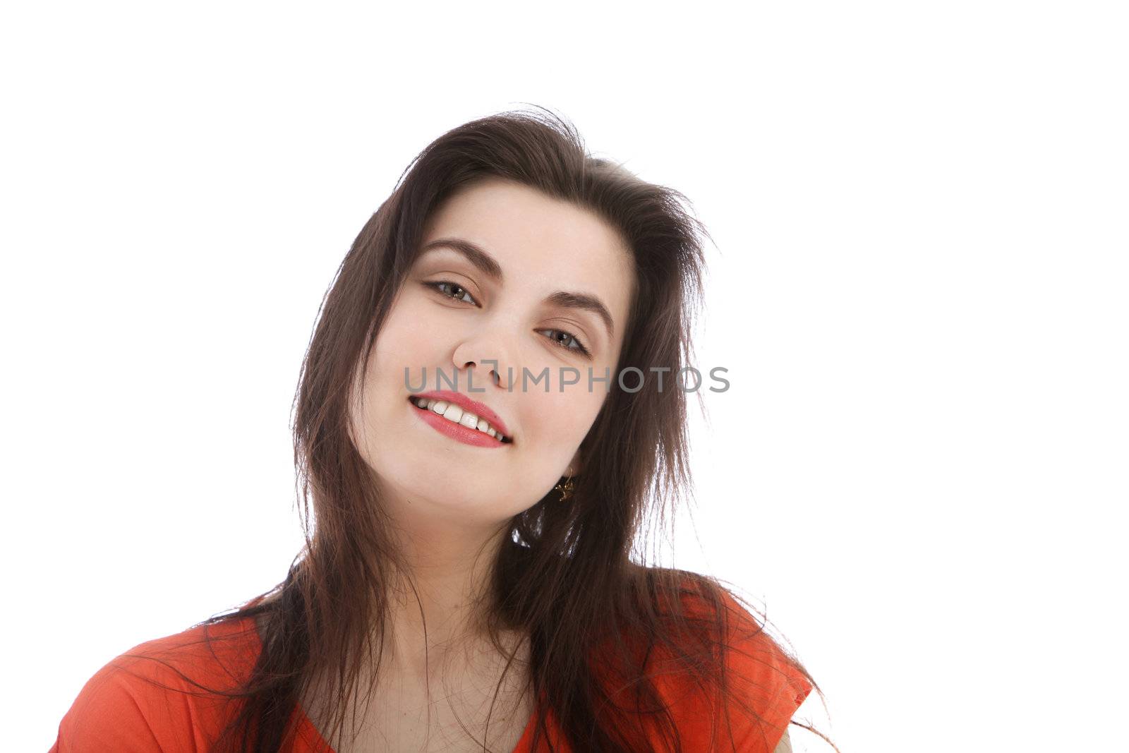 Portrait of a smiling brunette woman standing with her head slightly tilted to the side, head and shoulders on white