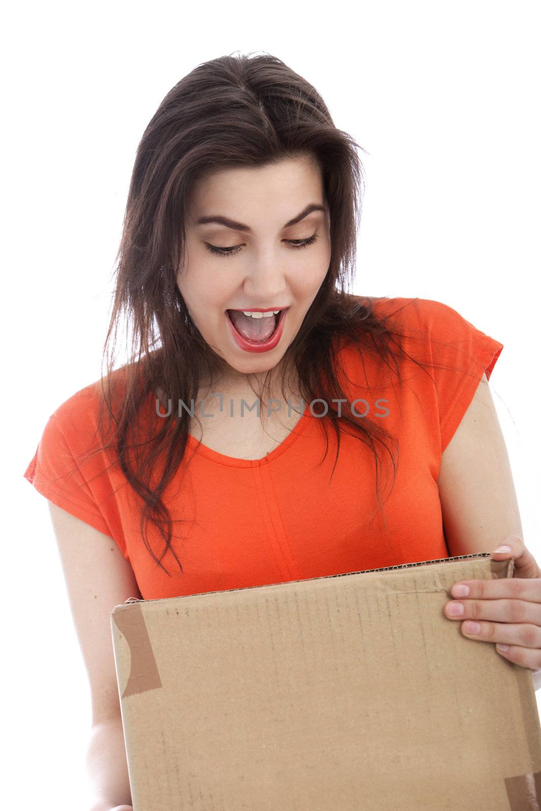 Surprised Caucasian young woman holding a cardboard box, portrait
