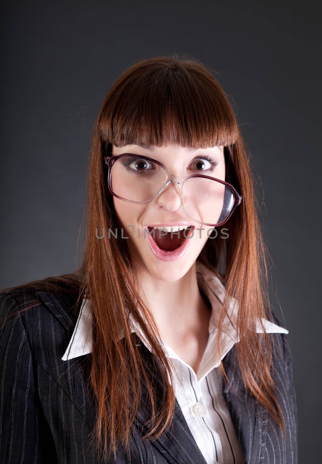 Funny businesswoman in old fashioned glasses, studio shot 