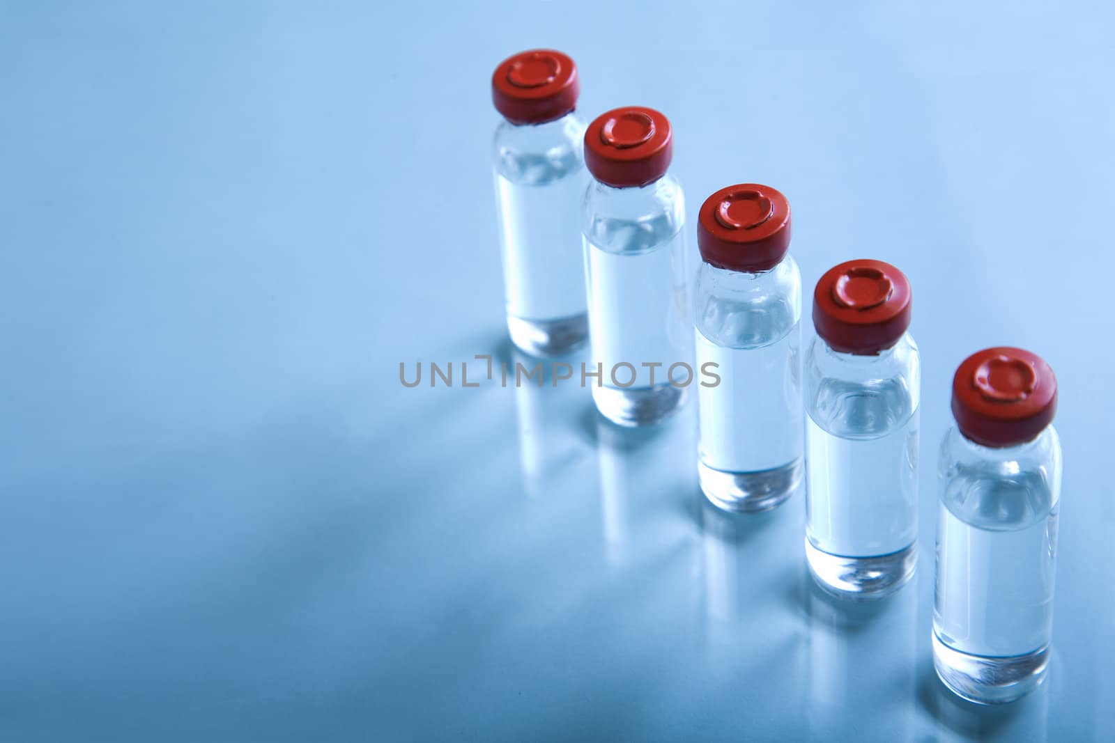 Vials with liquid for medicine or science, blue toned image, selective focus 