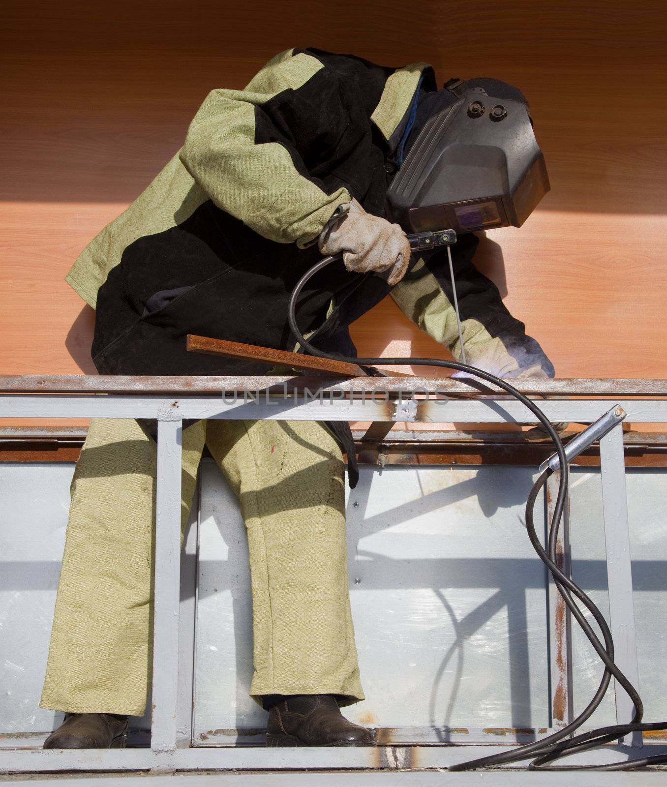 Welder in a special suit, while working in direct sunlight