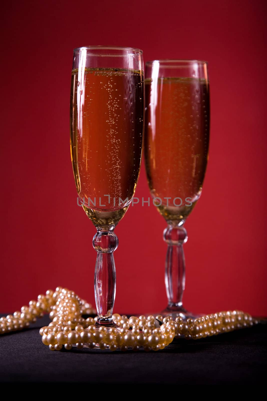 Champagne glasses with pearl necklace, selective focus 