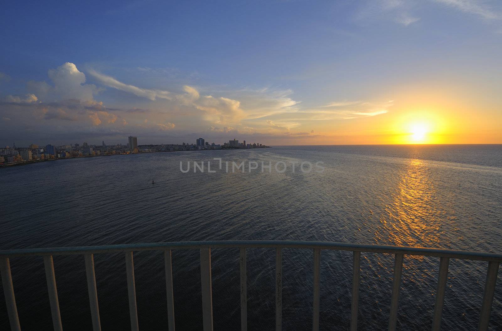 Havana bay entrance and city skyline at dusk with sun setting