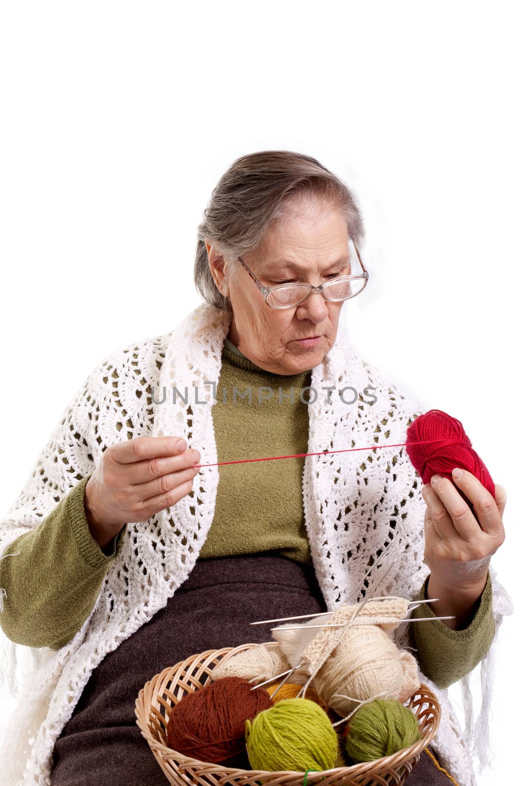 Senior lady sitting on her chair knitting