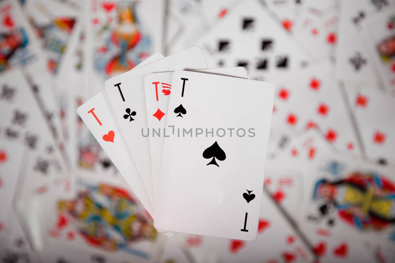 Close-up up of a four aces over blurred card background 