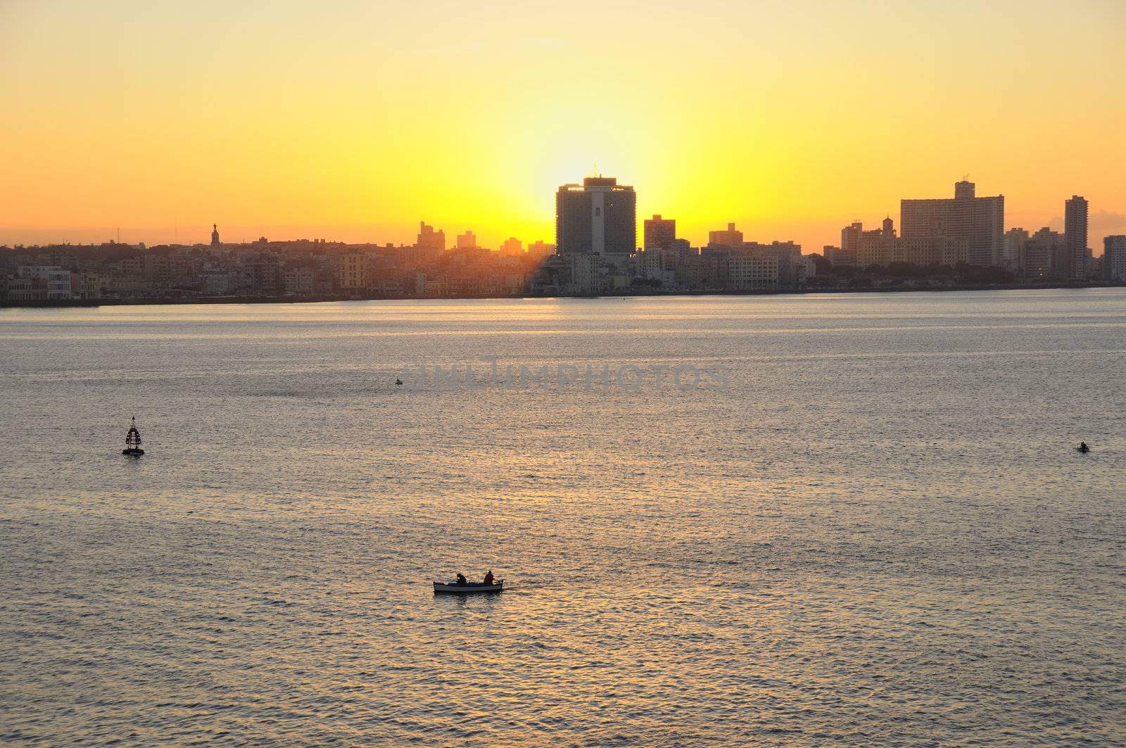 A view of havana skyline at sunset with fishing boat on the front