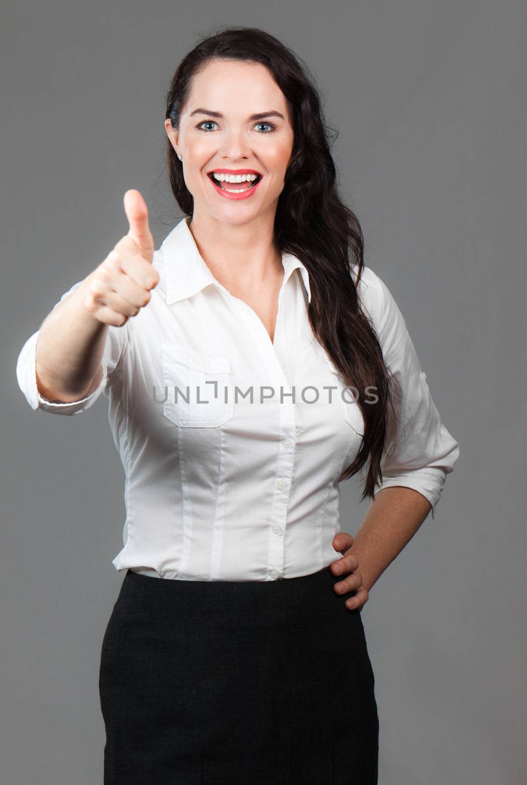 Happy woman giving thumbs up by Jaykayl