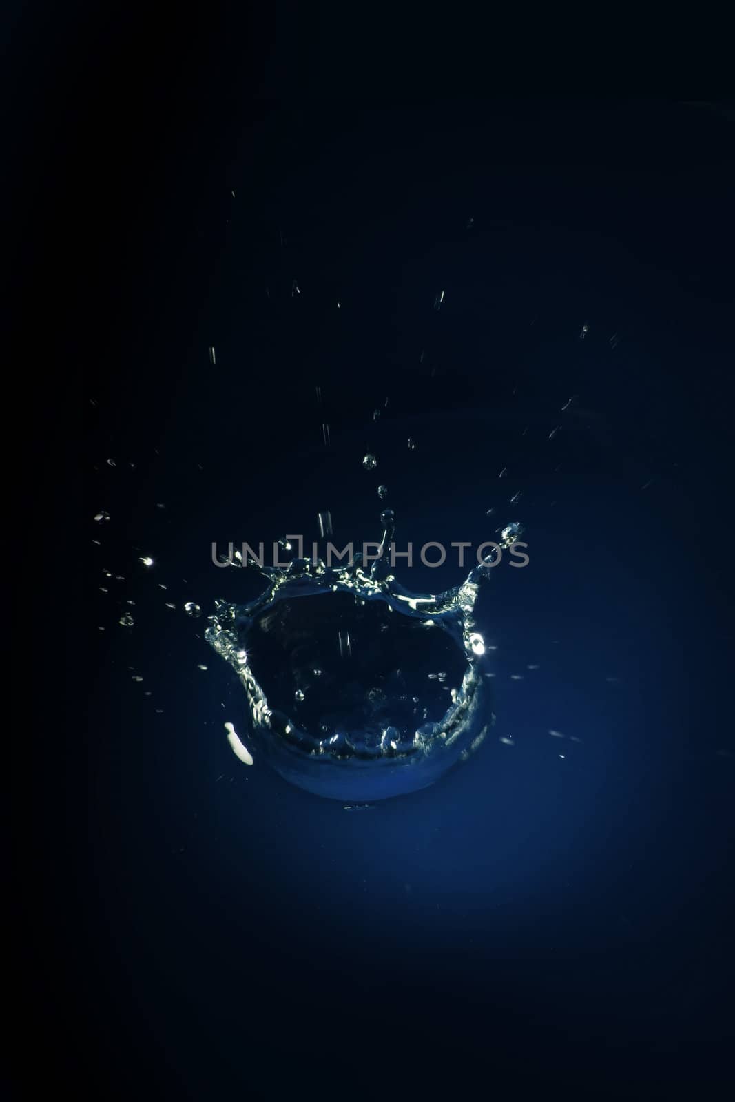 Water splash over dark blue background 