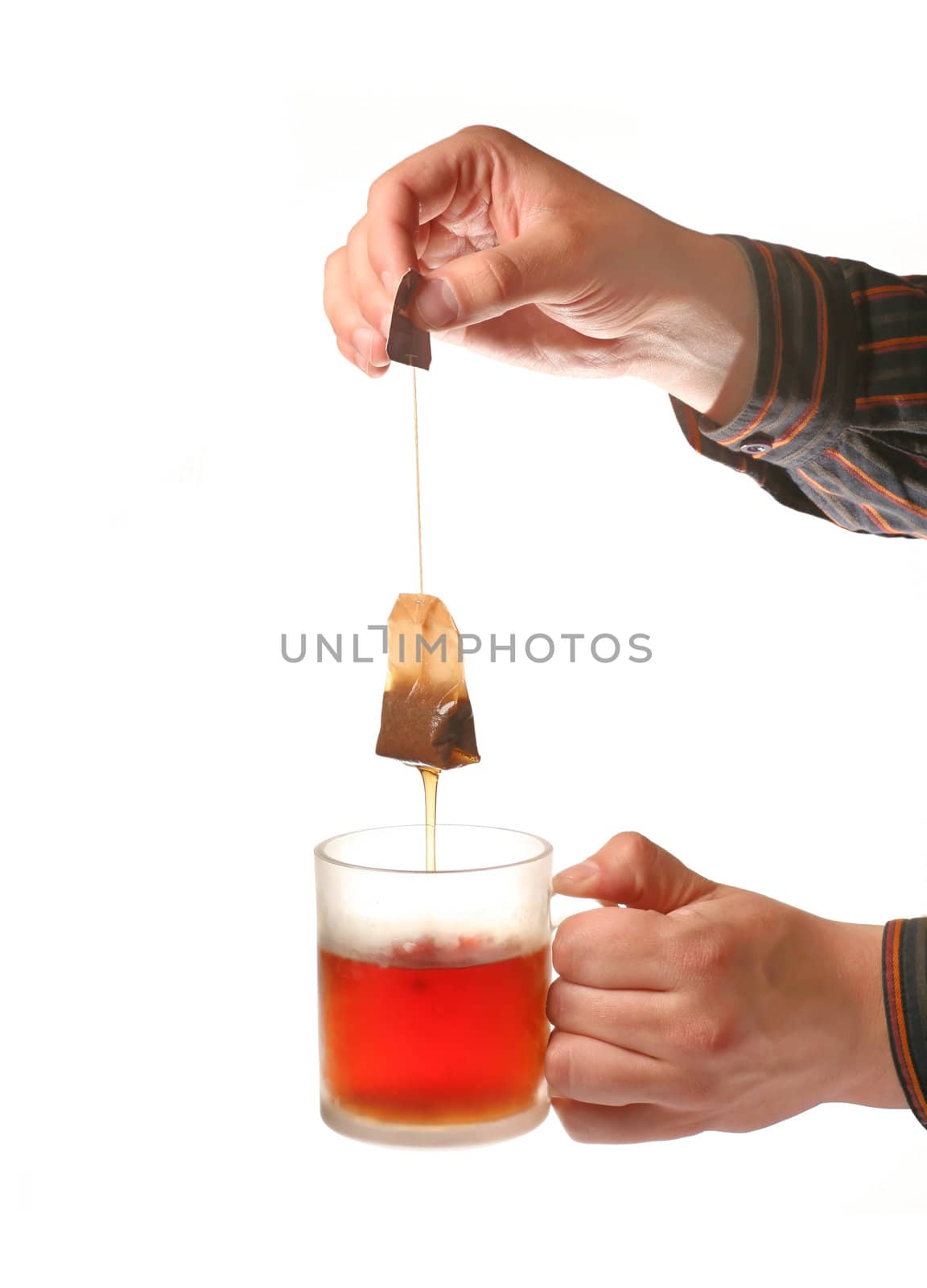 Mans hands holding tea cup and teabag by Elisanth