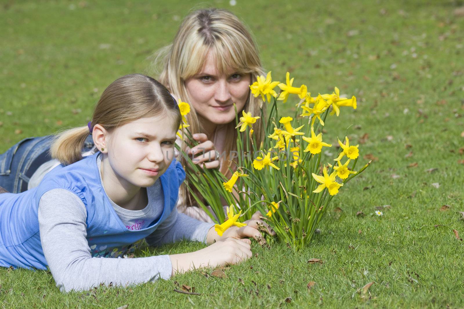  young woman and little girl in the park on a warm spring day