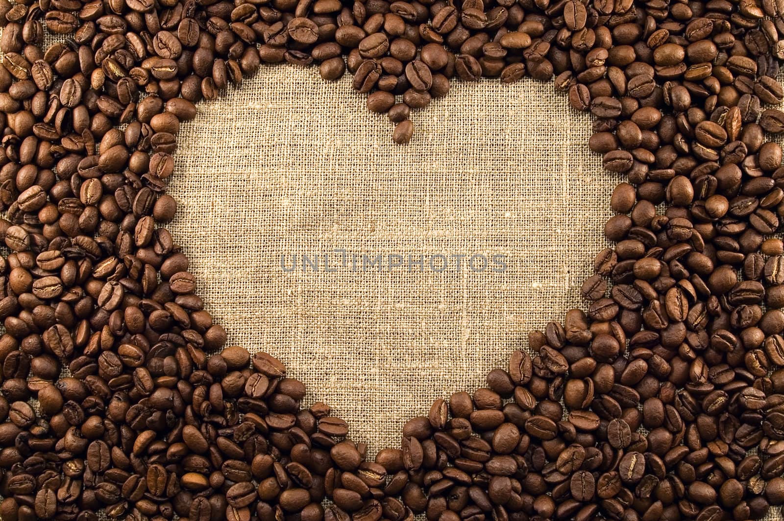 Coffee beans heart on light canvas