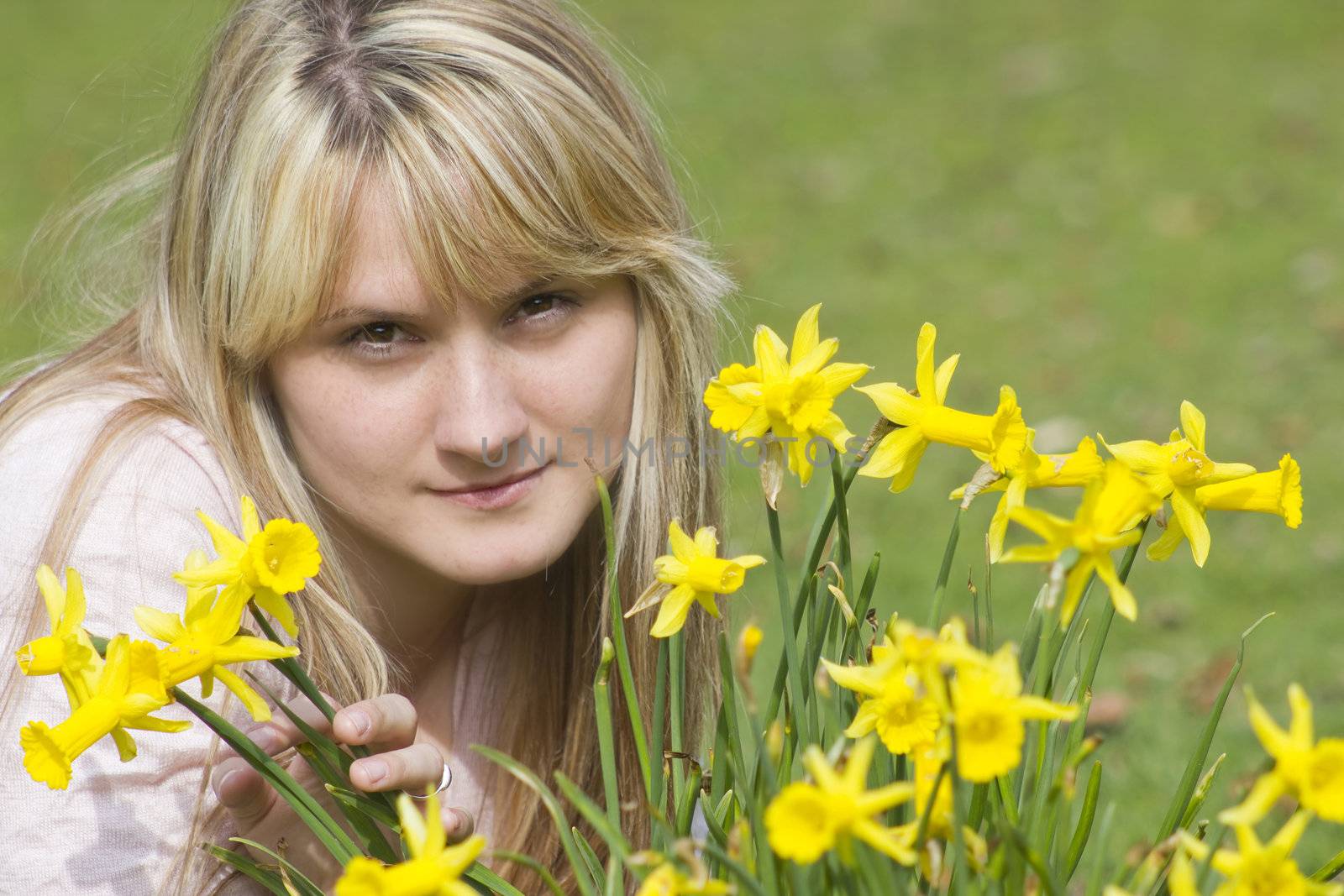 beautiful young woman with flowers on a warm spring day  by miradrozdowski