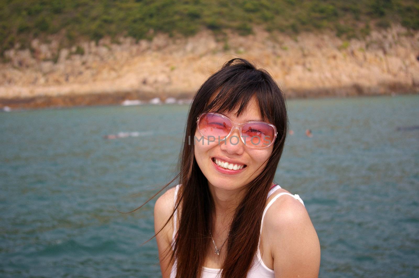 Asian woman smiling with sunglasses in summer