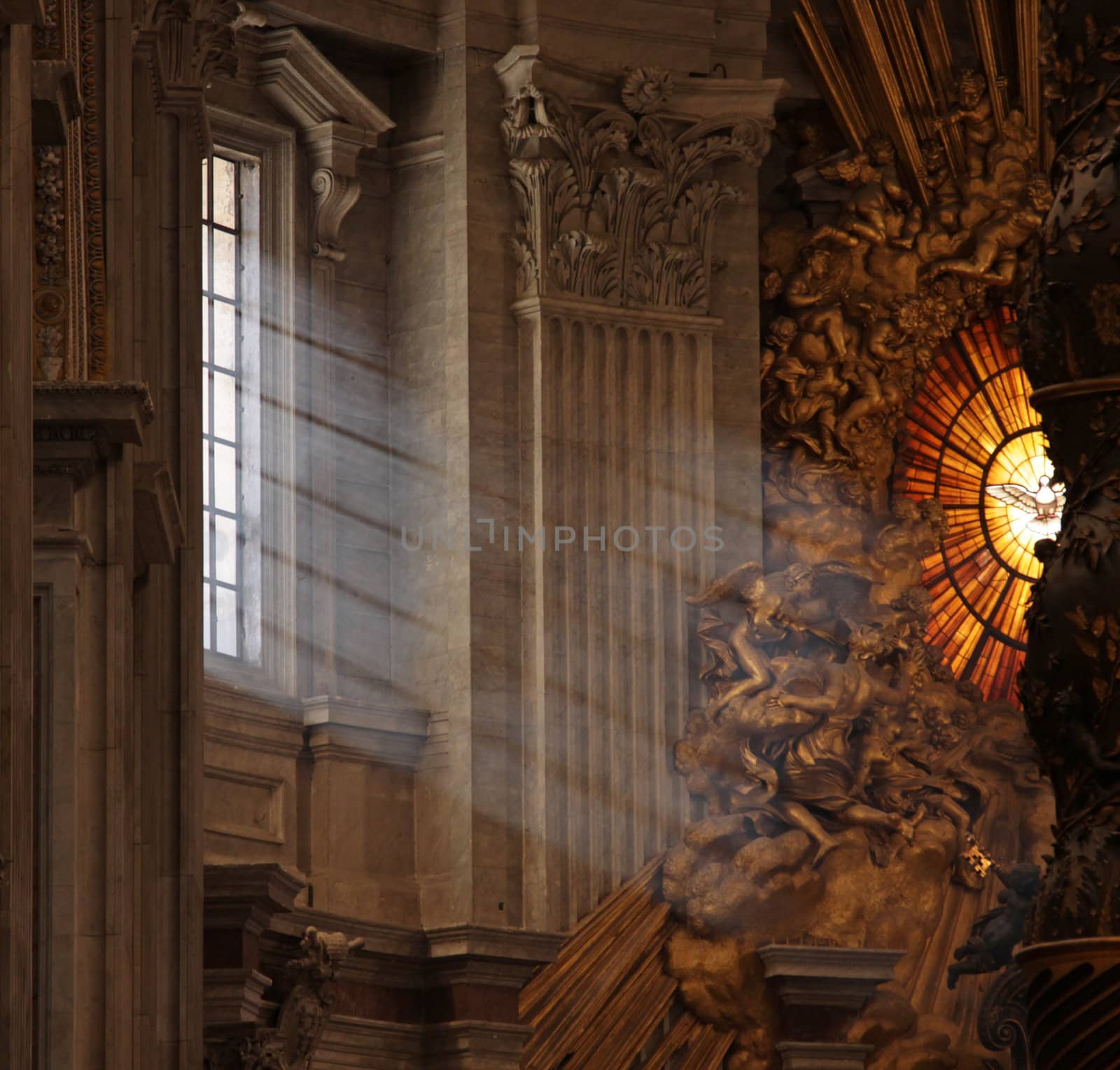 Rays of sunlight shine in the window onto the main altar of St. Peter's Basilica, in Rome, Italy.