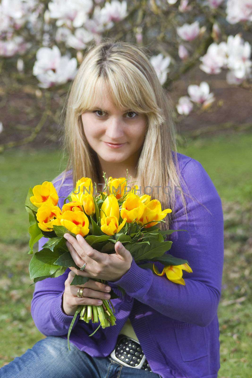 Happy woman holding flowers by miradrozdowski