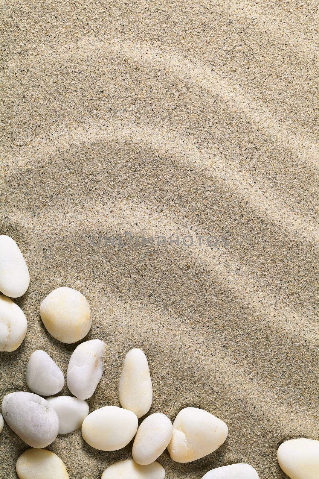 Sand background with stones for summer. Sandy beach texture. Macro shot. Copy space