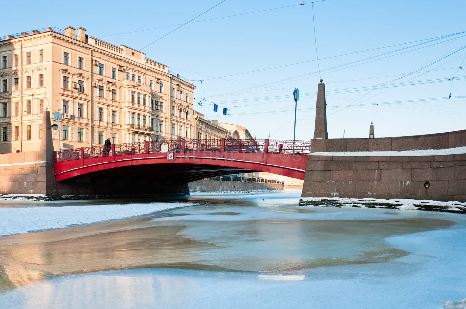 Small red bridge and frozen channel in Saint-Petersburg, Russia