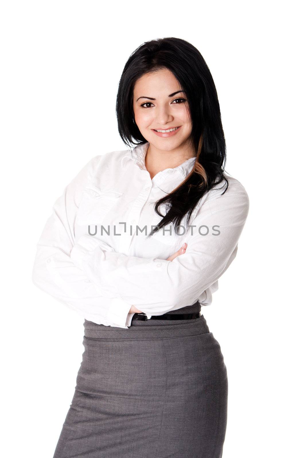 Beautiful happy smiling young corporate business woman MBA student standing with arms crossed wearing white blouse amd grey dress skirt, isolated.