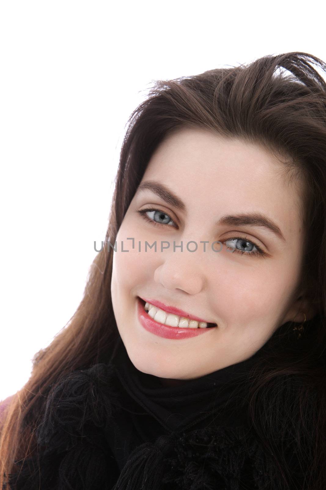 Blue eyed happy brunette young woman looking at camera, close up