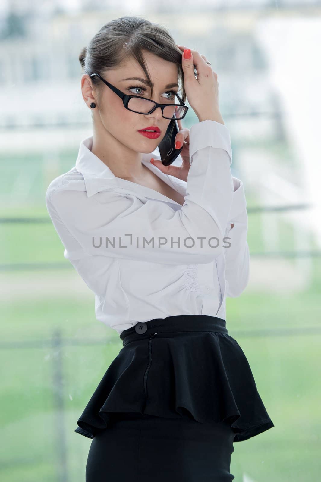 beautiful businesswoman with phone and laptop