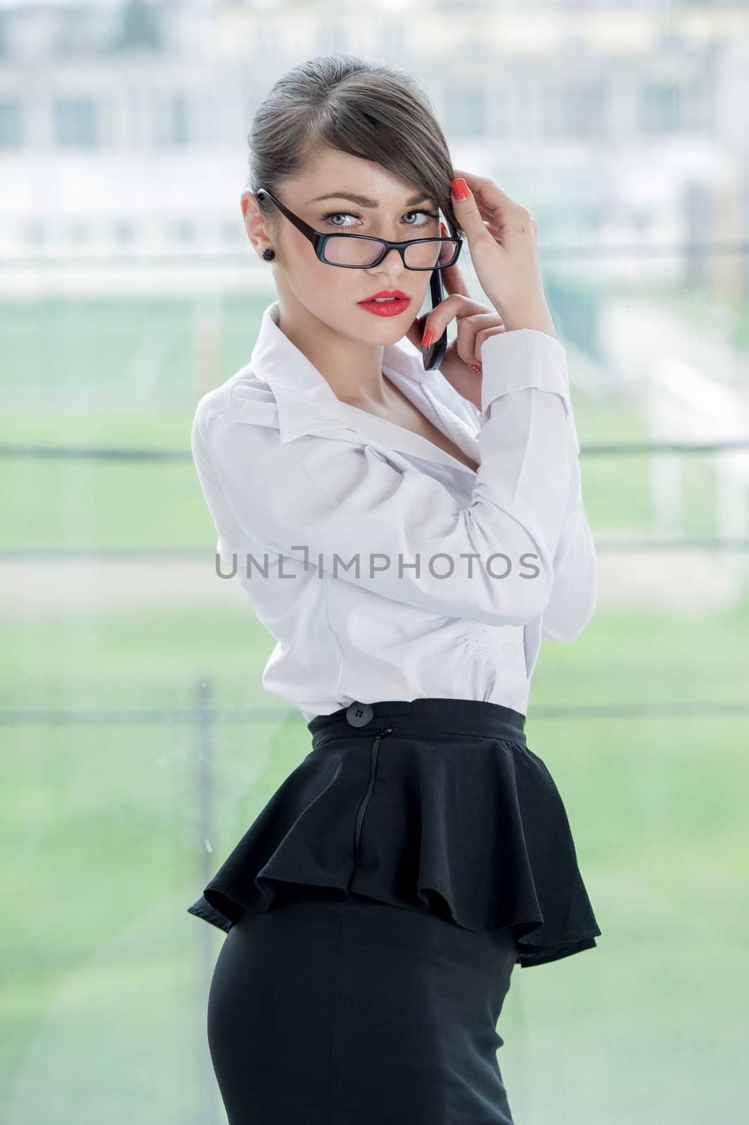 beautiful businesswoman with phone and laptop