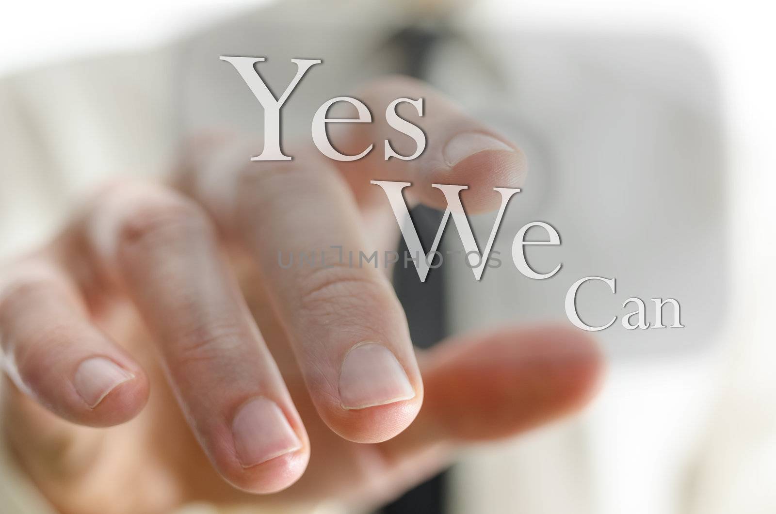 Male finger pointing at a Yes we can sign on a virtual screen.
